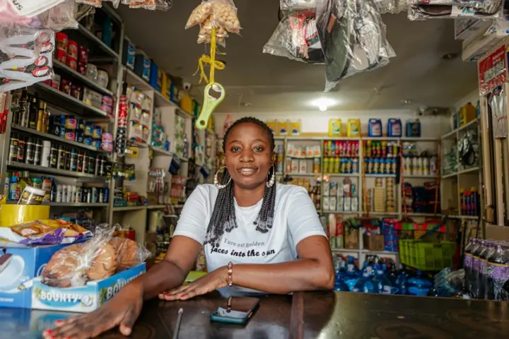 Shop owner smiling behind her counter